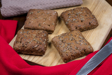 Swiss bread with seeds on a wooden cutting board