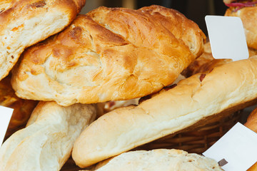 Close-up of different homemade breads in a bakery with label