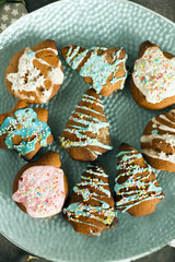 Gingerbread cookies, christmas cookies. Gray background, blue plate, christmas decorations. 