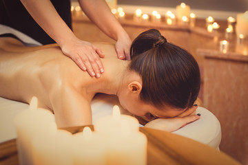 Relaxed girl getting massage at spa