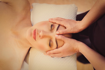 Fototapeta na wymiar Professional masseuse massaging female face
