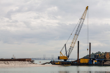 Fototapeta na wymiar Sand replenishment ship on shore for land reclamation