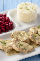 Grilled pork tenderloin in sour cream sauce with dill served with rice and beetroot salad.