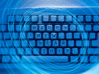 keyboard with inscription Happy New Year 2017 illuminated by blue light