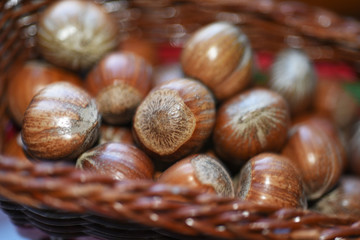 Macro photo of nuts in straw plate.