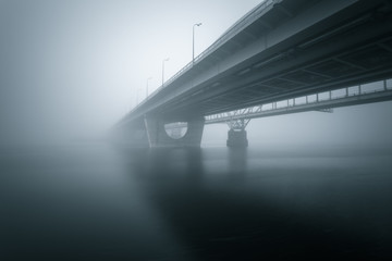 Two parallel bridges over foggy river. Long exposure shot.