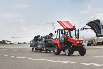 Fototapeta premium Vehicle with baggage near plane