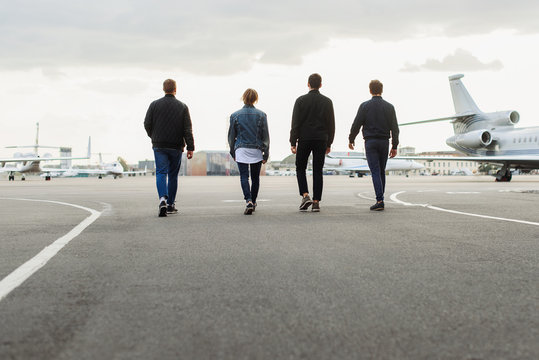Young men walking on airfield