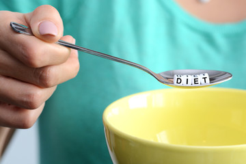 Diet plan concept with little spoon and empty bowl