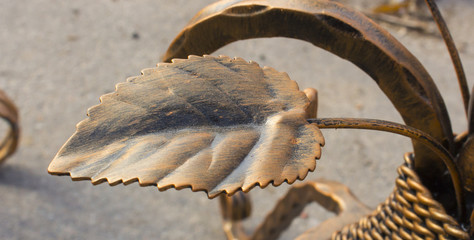 Forged metal fence with decorative elements in the form of gold leaf