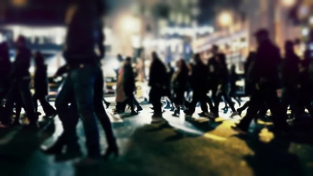 City pedestrians on winter night, cross street, slowmo 100p.Stabilized dolly shot of an anonymous crowd of pedestrians  crossing a busy intersection at night.No logos/faces visible.Commercial shot.