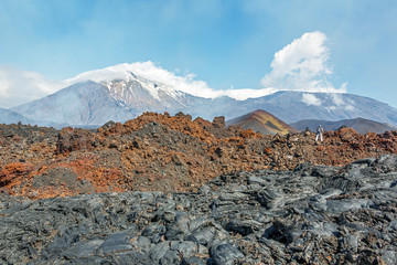 KAMCHATKA, RUSSIA - AUGUST 28, 2013:Tourist go on a route through the active lava flow from a new...
