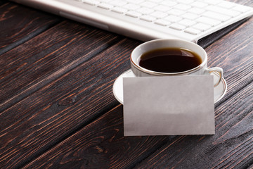 Coffee and card on wood background
