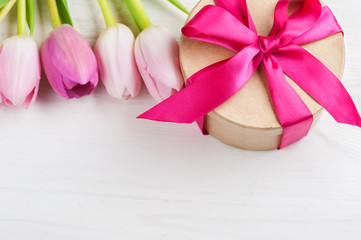 Red pink yellow tulips and gift box with red ribbon