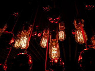 Red shining lanterns hanging under the ceiling in a restaurant