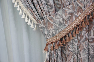 Fragment of the beautifully decorated curtains. Interior