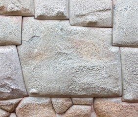 The multi-sided granite stones in ancient Inca wall street Hatunrumiyoc - Cusco, Peru