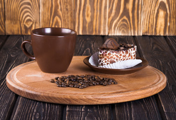 Brown cup with coffee bean and cake