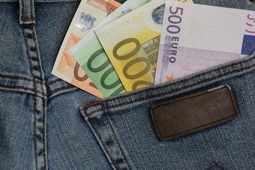 Money sticking out of a pocket of jeans