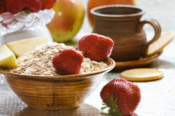 Fruit still life with cereal with strawberries and apples.