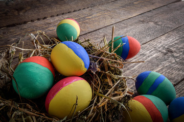 painted Easter eggs on wooden background