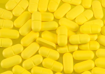 Fototapeta na wymiar background of yellow oval tablets