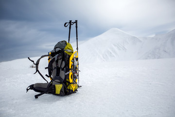 Backpack in wintertime against big snowy mountain