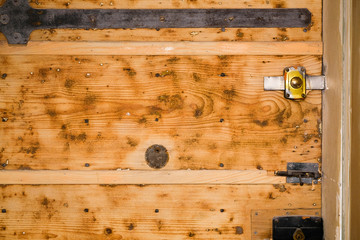 Old wooden door with metal knocker and fifting..