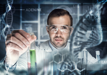 Young scientist mixing reagents in glass flask in clinical laboratory