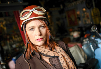 Elegant sexy female in red skirt posing in and out vintage scoot