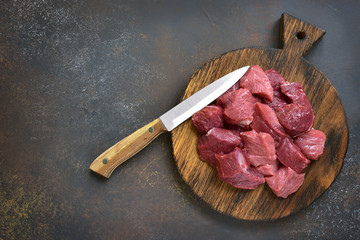 Raw chopped beef on a wooden cutting board.Top view.