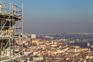 Scaffolding above a city with a clear sky