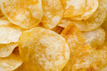 Close up potato chips on wood top view background.