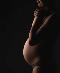 Portrait of young pregnant girl expecting. Silhouette. Pregnancy