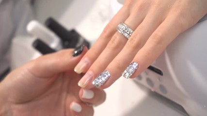 Manicure artist making professional manicure