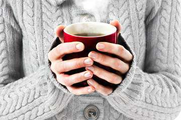 hot red cup in woman's hands