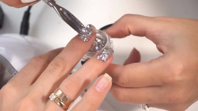 Manicure artist making professional manicure in spa salon