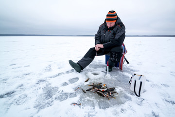 Fototapeta na wymiar Happy winter fishing in a lake