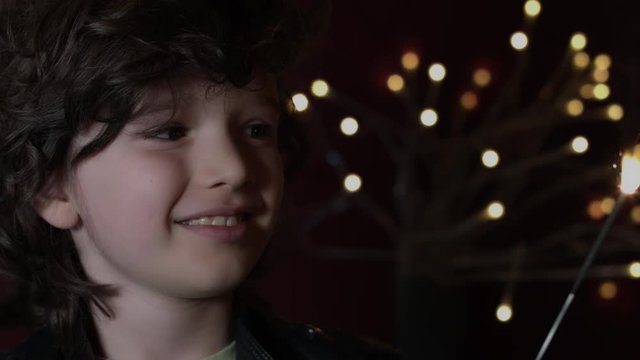 4k Shot of a Cute Child in Studio Smiling with Bengal Light -Christmas firework