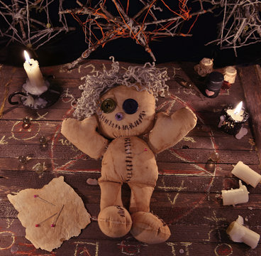 Voodoo ritual with doll and magic objects