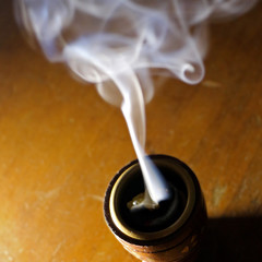 Incense burner against dark background swirling smoke natural wood Frankincense, Myrrh Resin