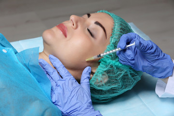 Obraz na płótnie Canvas Procedure of facial injection closeup