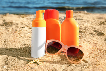 Sunscreen cream, sunglasses and starfish on sea coast