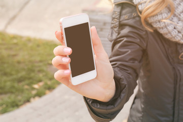 Closeup of female hand holding smartphone