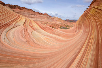 Colorful and swirling sandstone rock formations at The Wave - a dramatic and colorful erosional sandstone rock formation located in North Coyote Buttes area of Paria Canyon-Vermilion Cliffs Wilderness