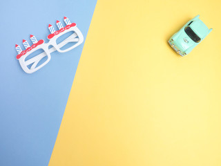 Top view for birthday concept to create idea copy space on color background.Cute object car vintage and glasses composition.