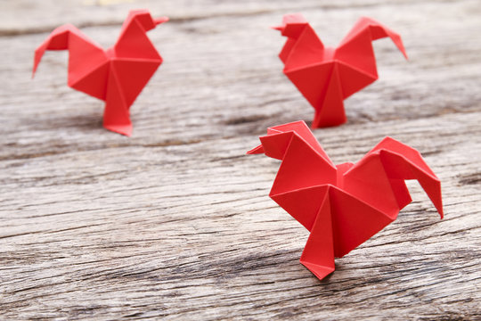 Red Origami Chicken On Wooden Surface