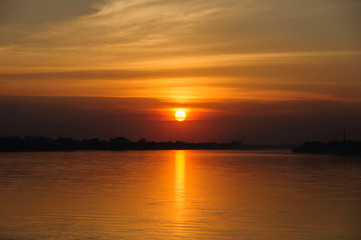 Fototapeta premium Sunset on the river sides of Thailand and Laos. The photo was taken from Thailand side in the evening.
