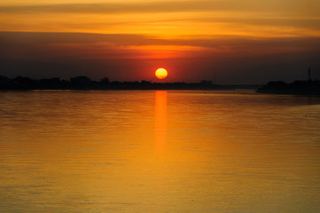 Naklejka premium Sunset on the river sides of Thailand and Laos. The photo was taken from Thailand side in the evening.