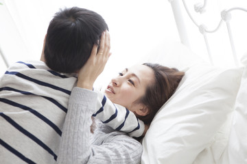 My mother and son are lying on the bed